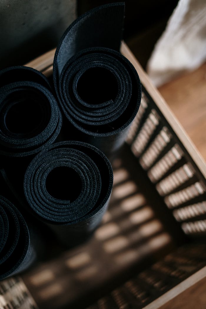 our-services-2 Close-up of rolled yoga mats in a basket at a fitness studio, ideal for yoga or pilates.